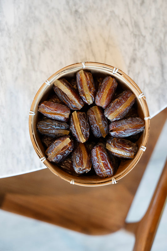 Palestinian Medjool Dates filled with Orange Peel in a wooden basket