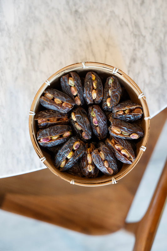 Palestinian Medjool Dates with Pistachio in a wooden bowl