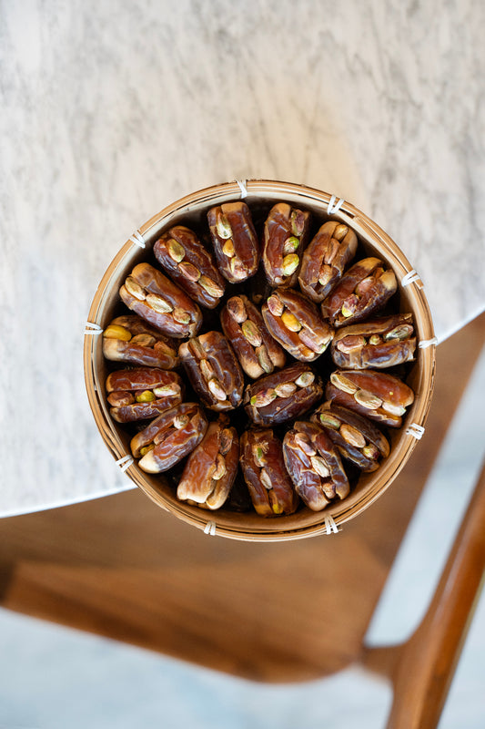 Sagai Dates with Pistachio in a wooden bowl