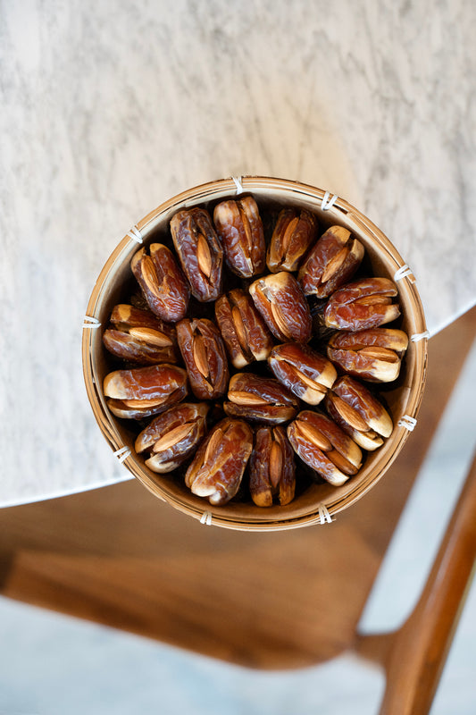 Sagai Dates with Almonds in a wooden bowl